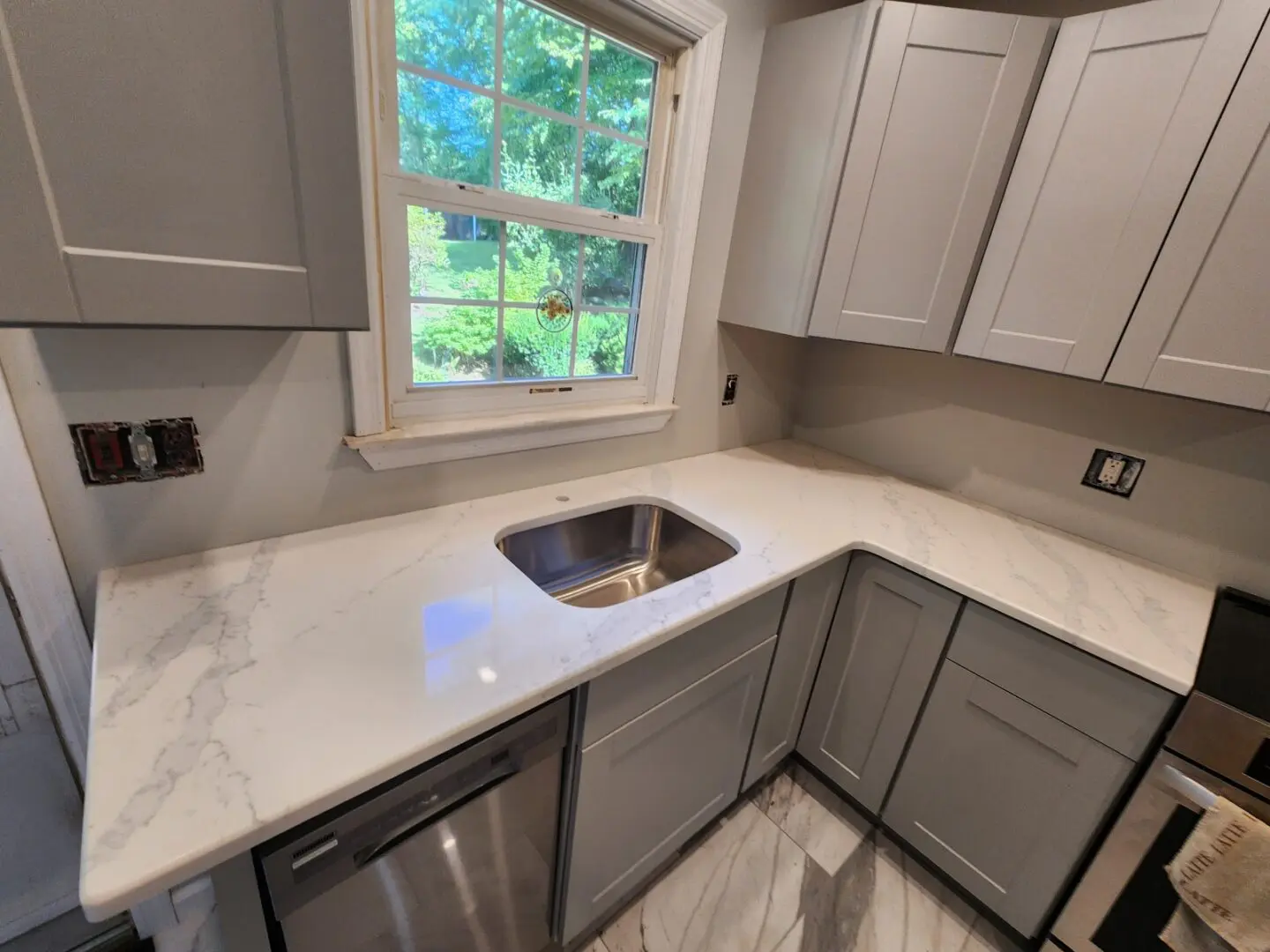 Kitchen countertop with white quartz and sink.