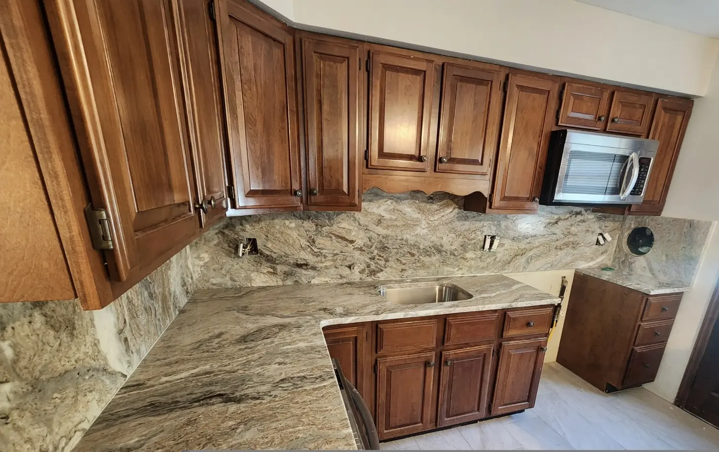 Kitchen with wood cabinets and granite counters.