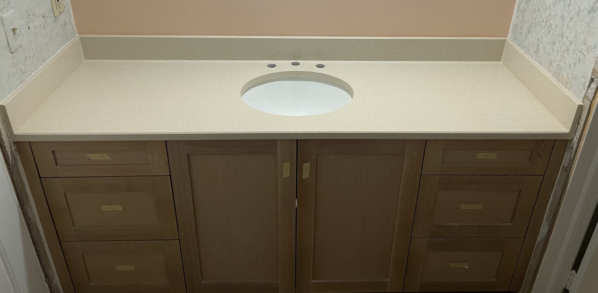 Beige bathroom vanity with sink.