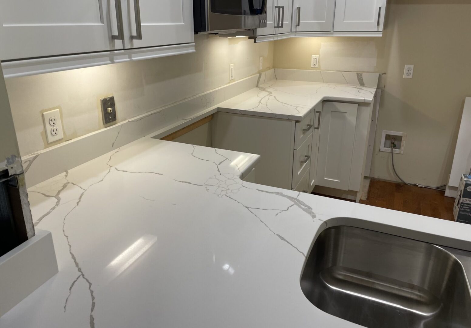 White quartz kitchen countertop with sink.