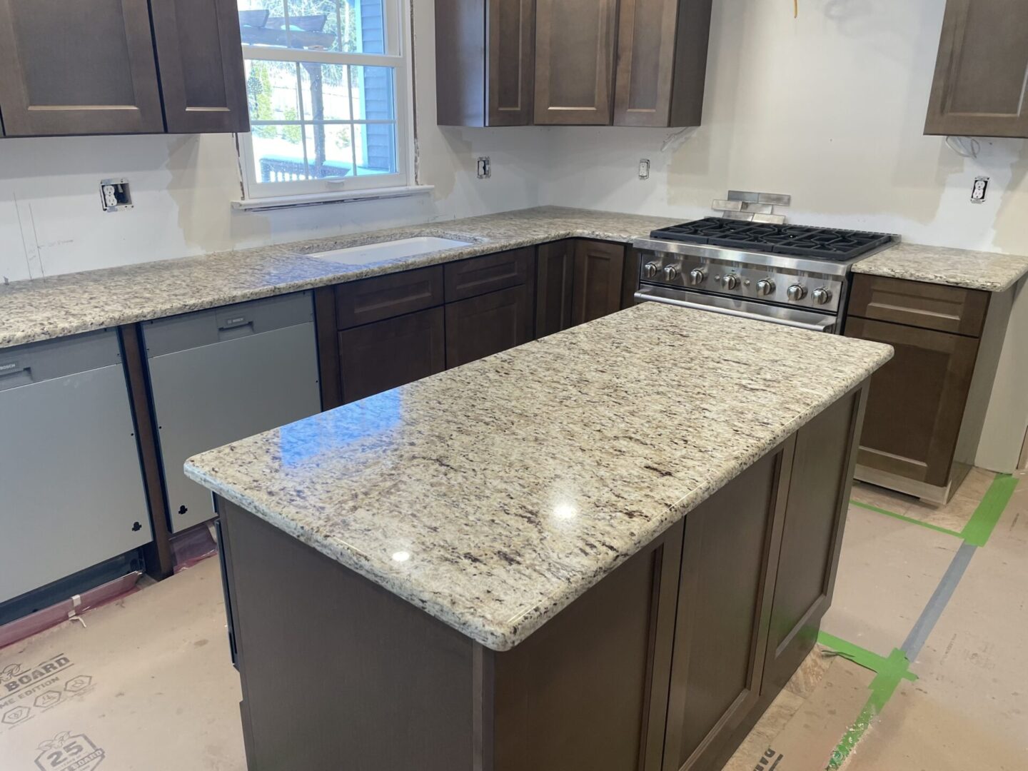 New kitchen with granite countertops.