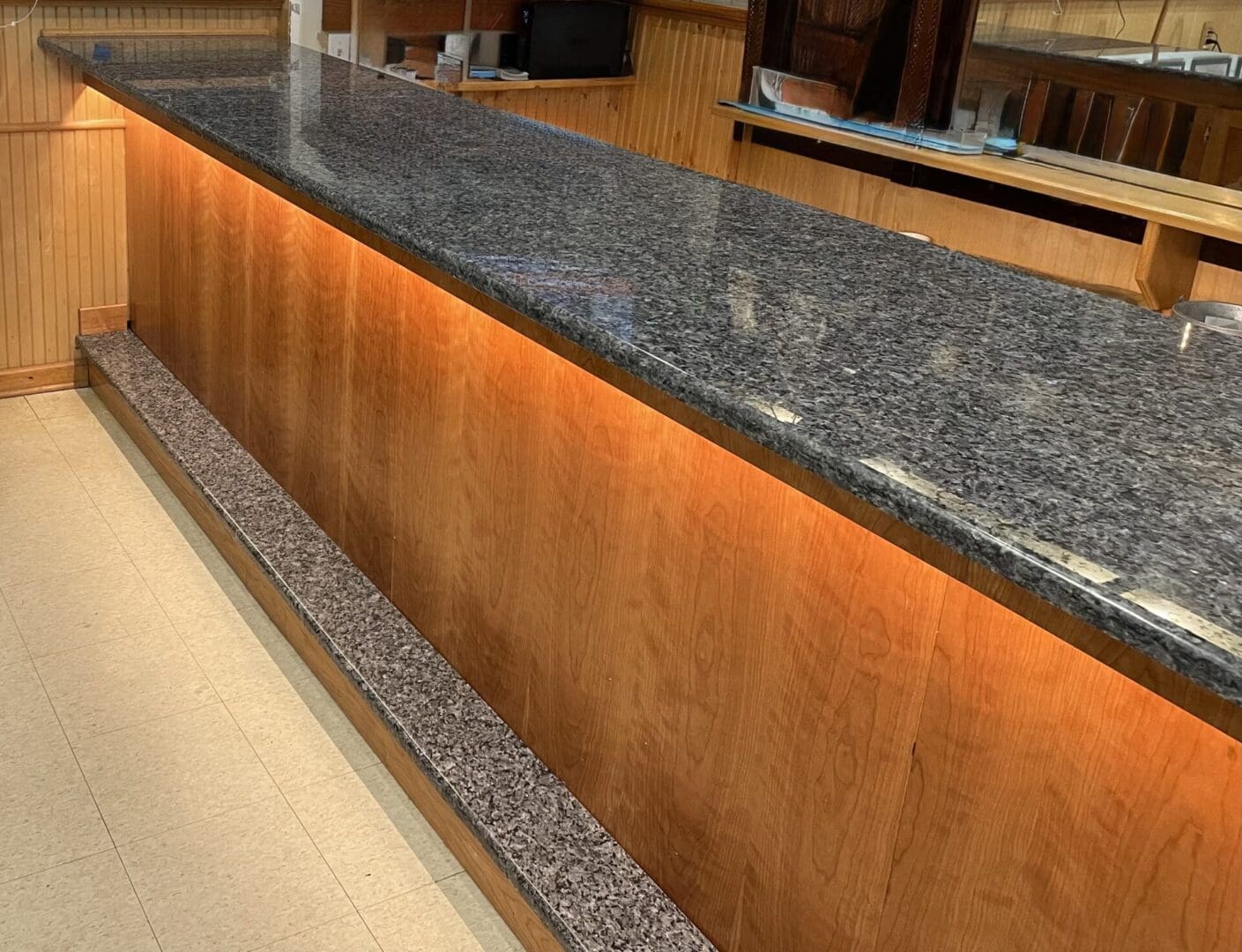 Granite countertop bar with wood base.