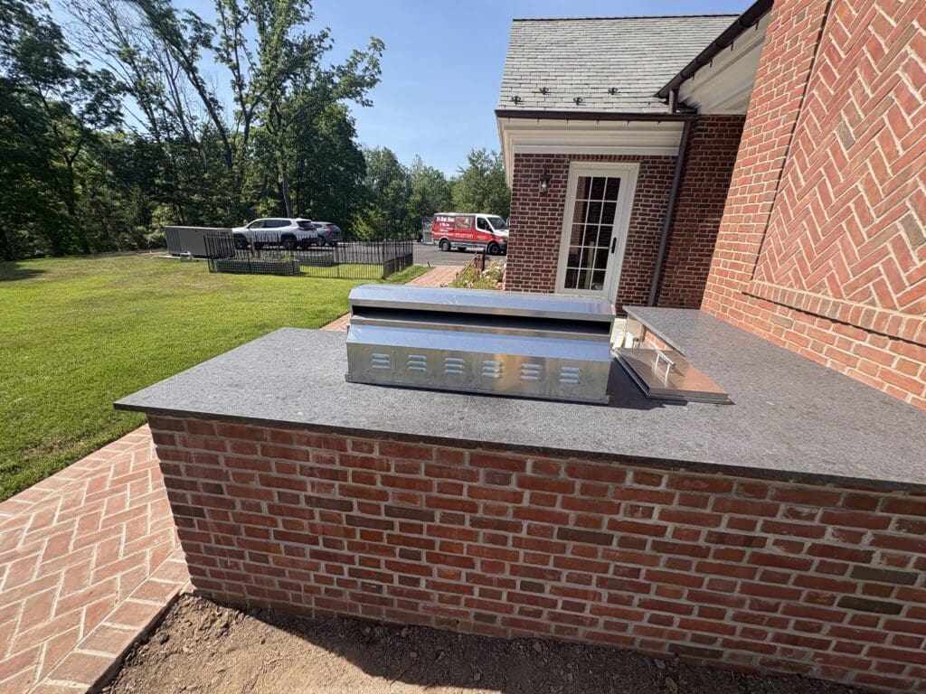 Outdoor kitchen brick counter with stainless vent